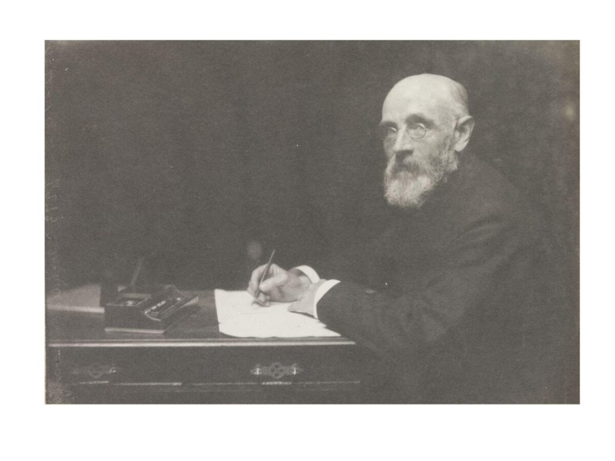 Elderly Man Writing at Desk
