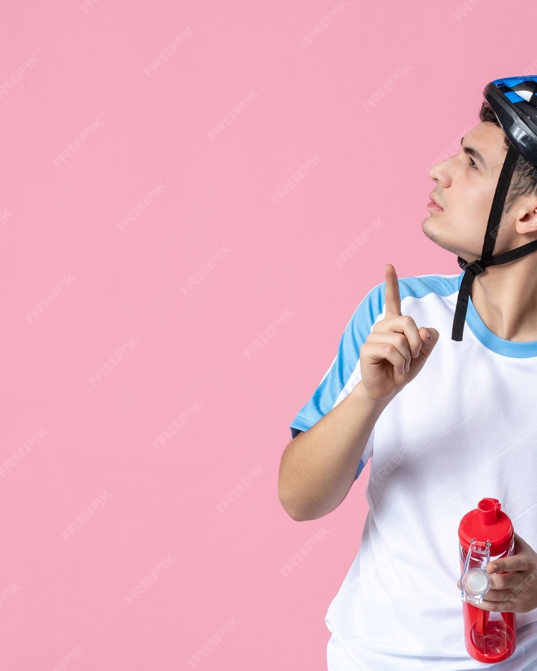 Young Cyclist Pointing to Empty Space