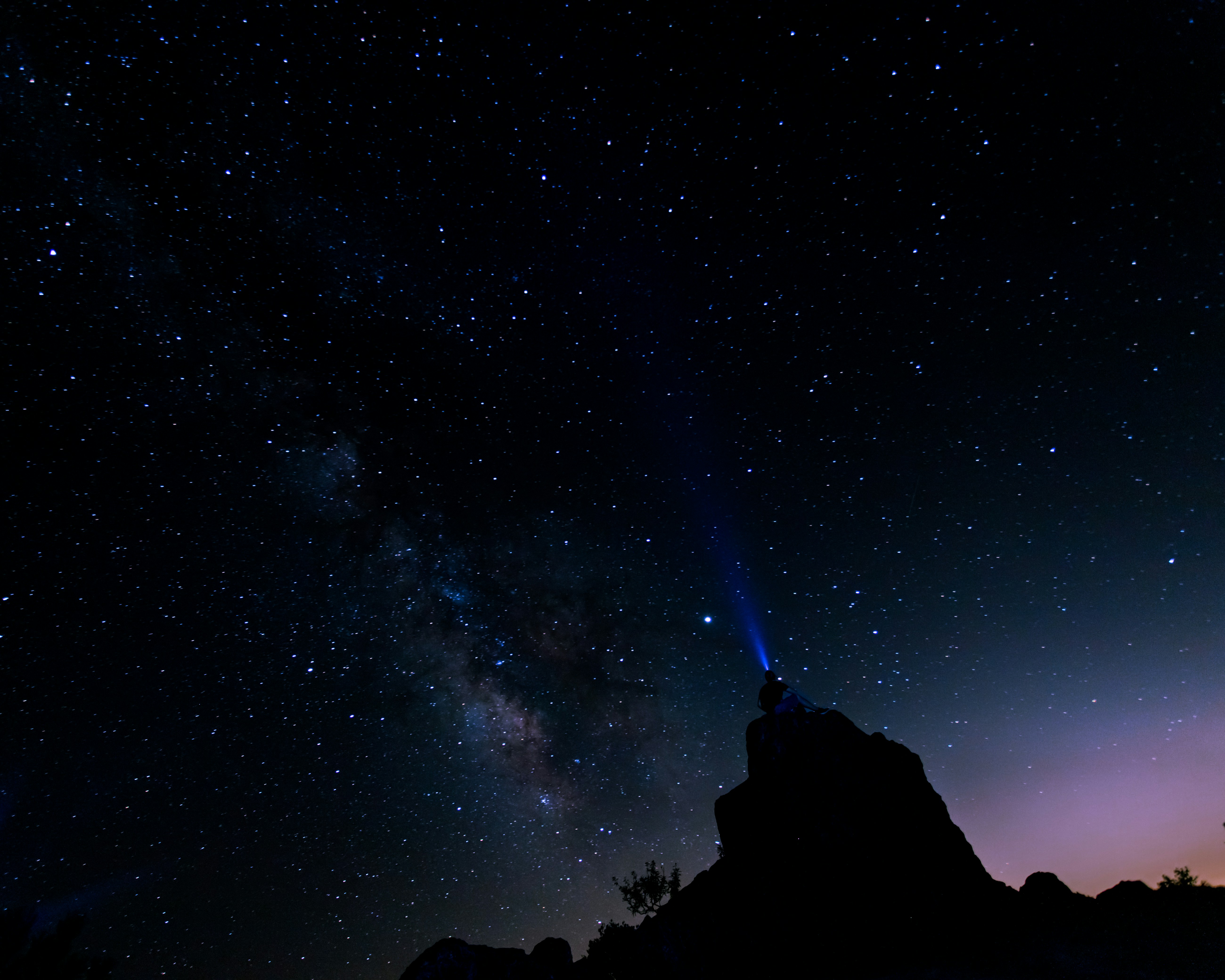 Stargazer on Peak Under Starry Sky