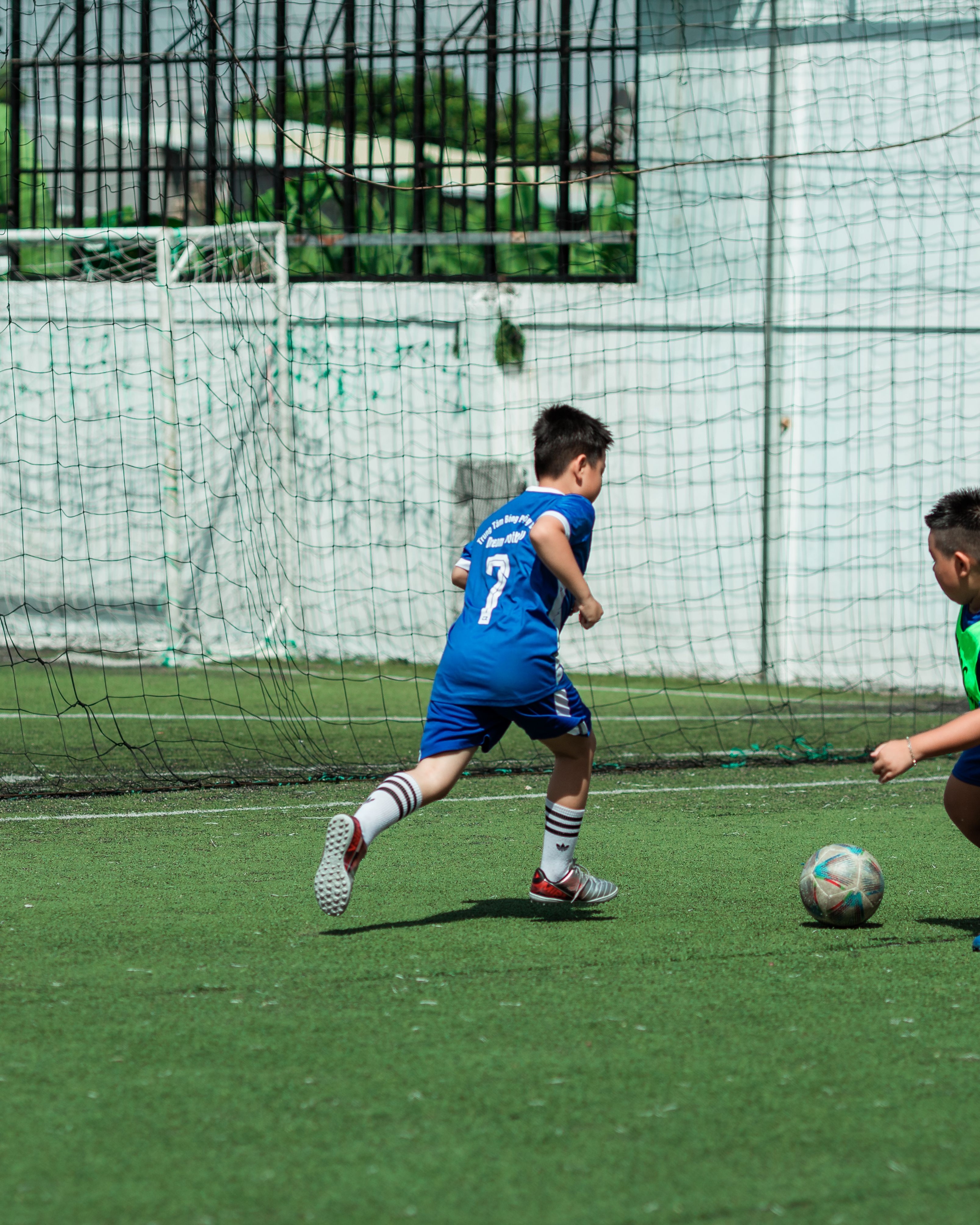 Young Boys Playing Soccer on Field
