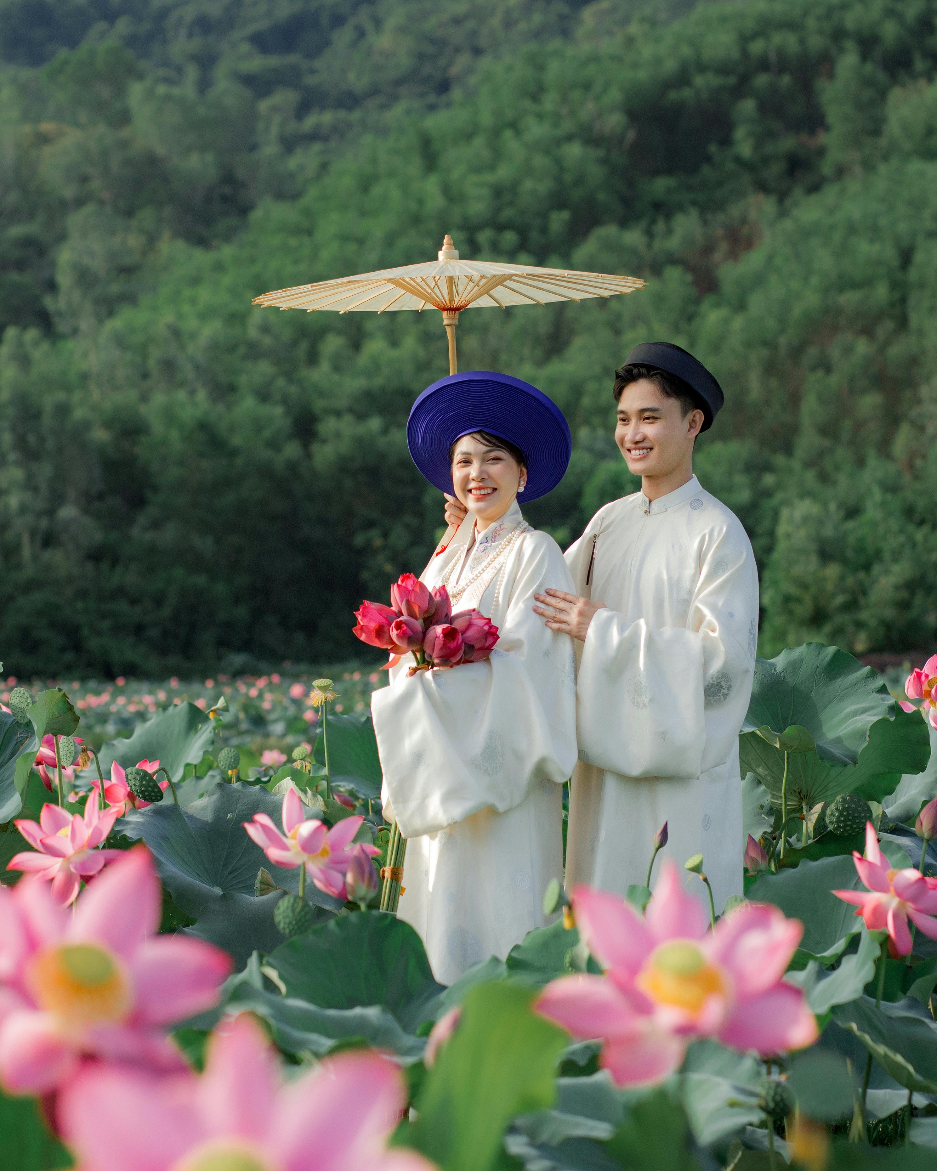 Couple in Traditional Dress in Lotus Field