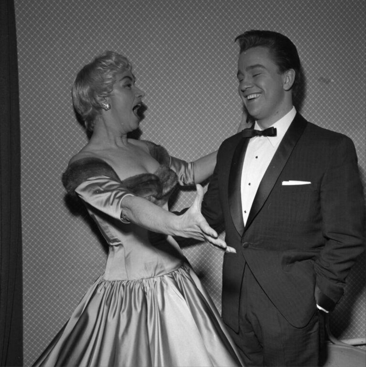 Woman Reacting to Laughing Man in Tuxedo