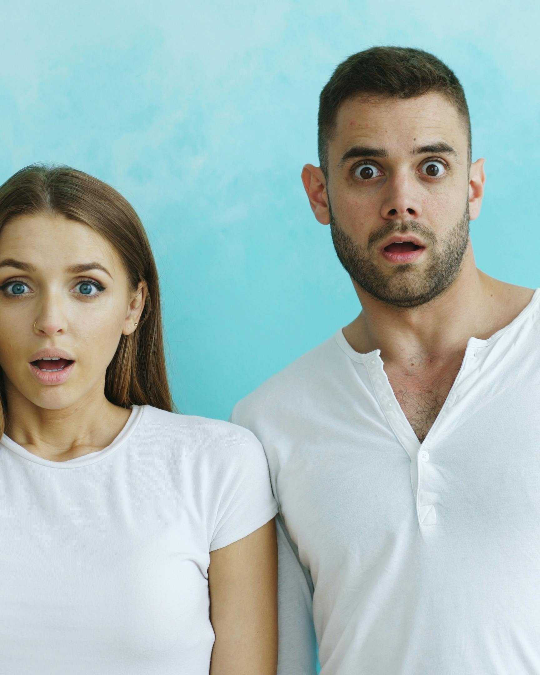 Shocked Man and Woman Staring at Camera