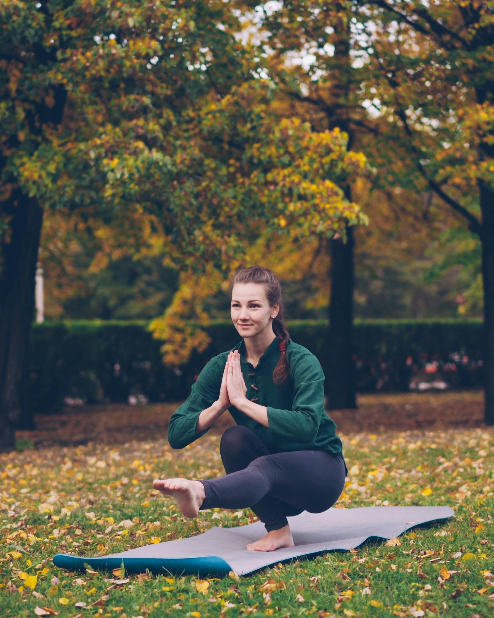 Woman Doing Yoga in Autumn Park