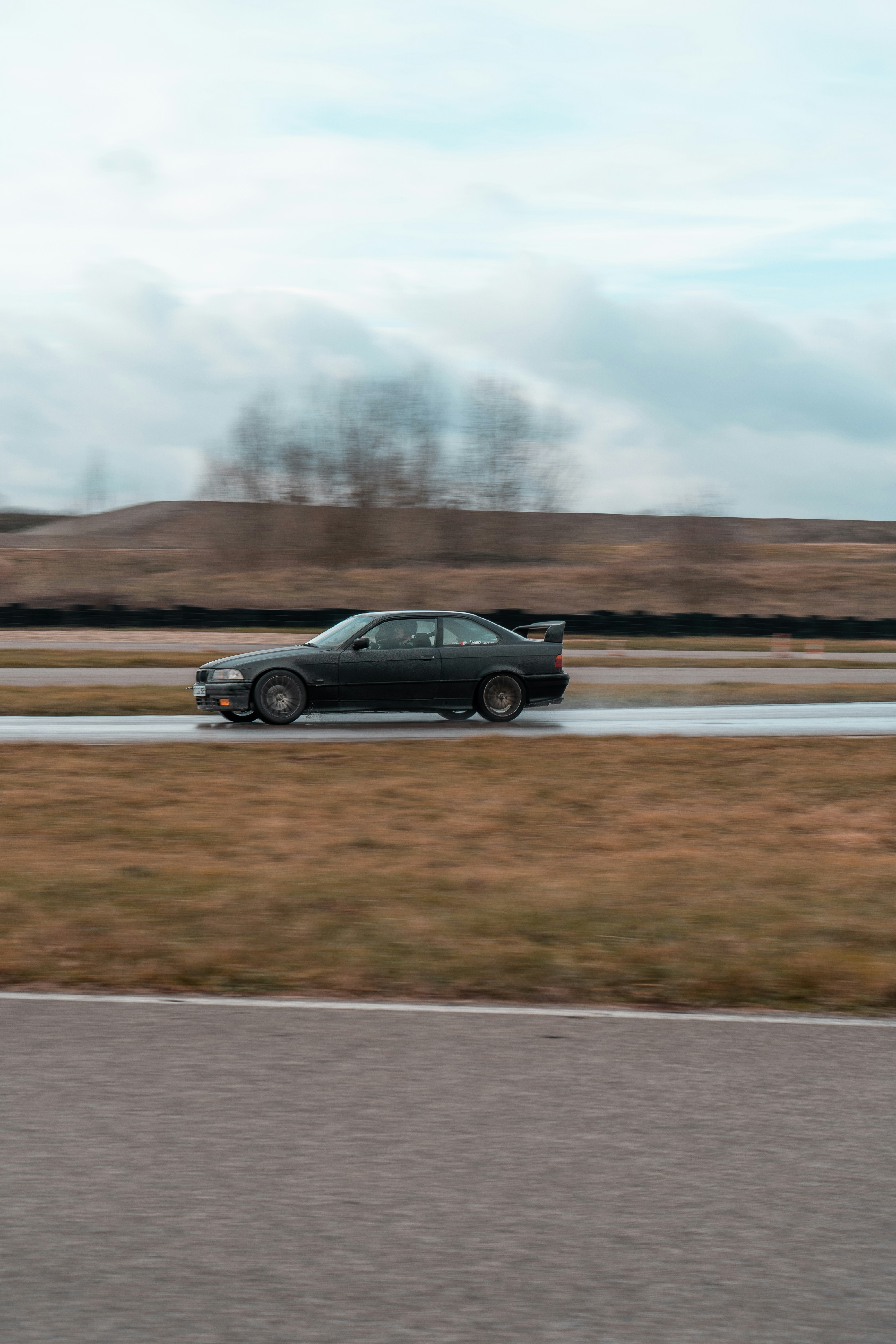 Black Sports Car Drifting on Race Track