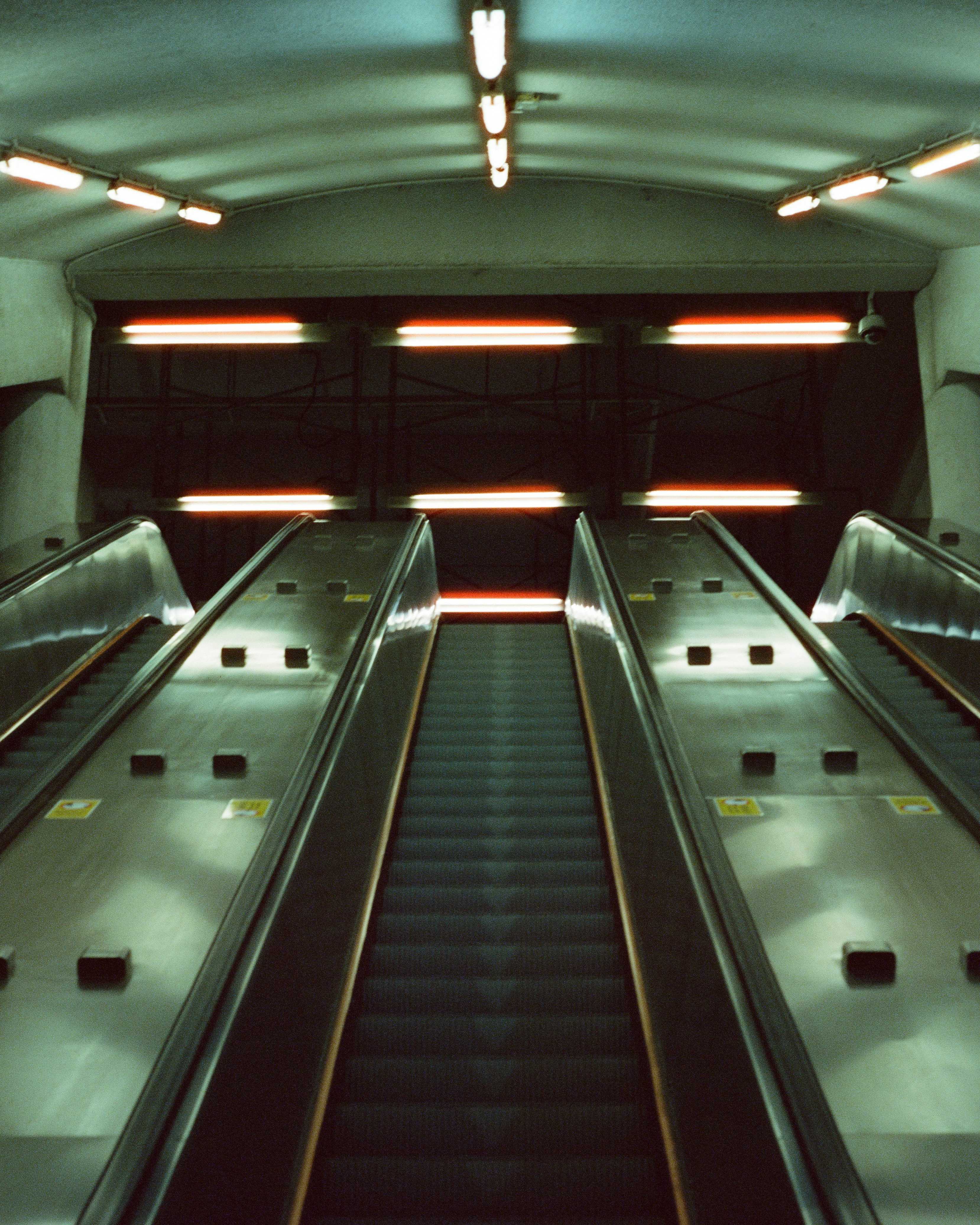 Upward Escalators in Underground Tunnel — City