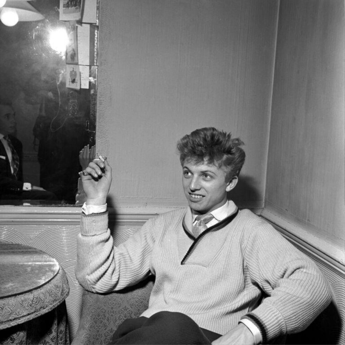 Young Man Relaxing in Corner Booth