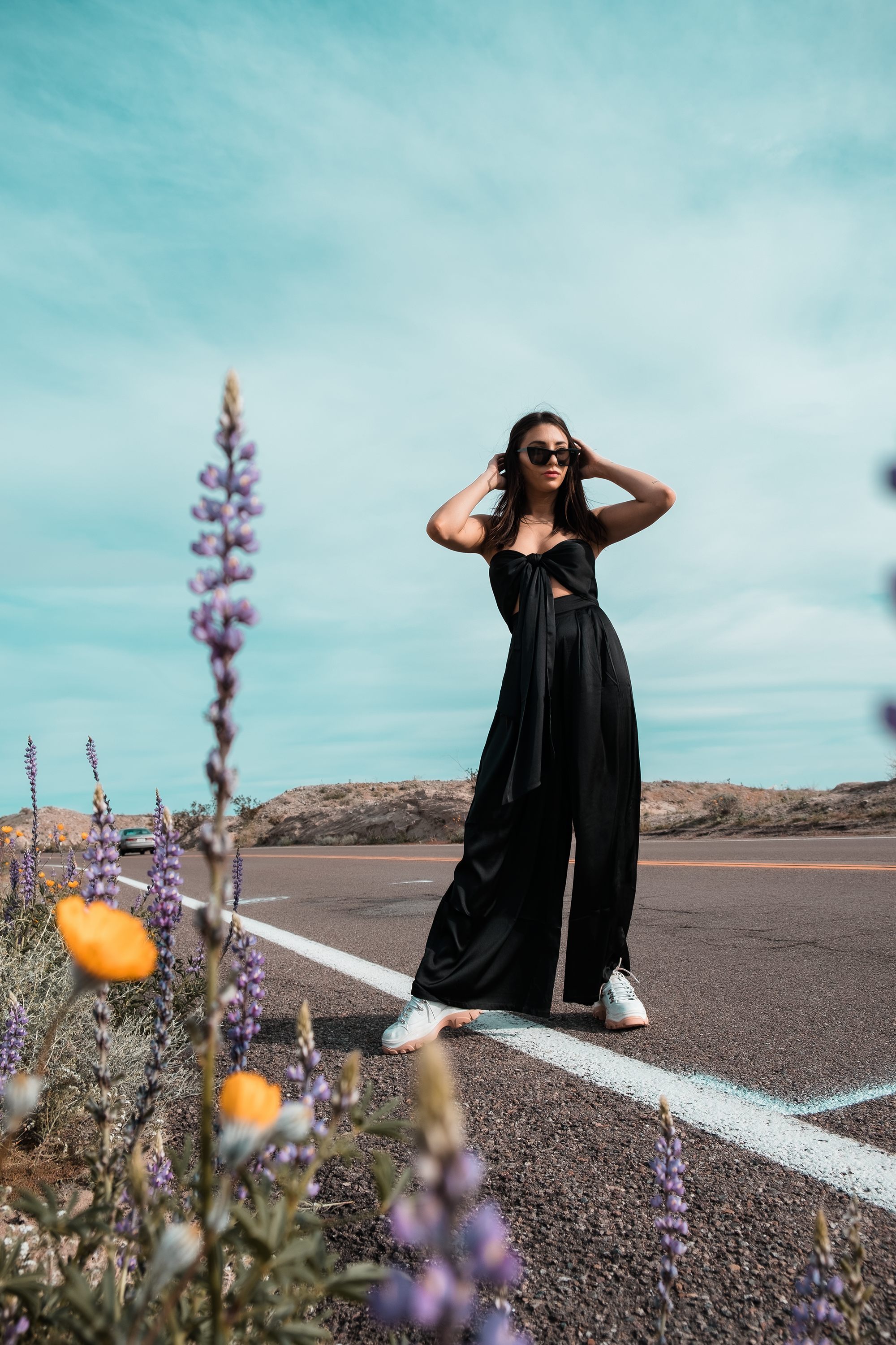 Woman Posing on Roadside With Wildflowers
