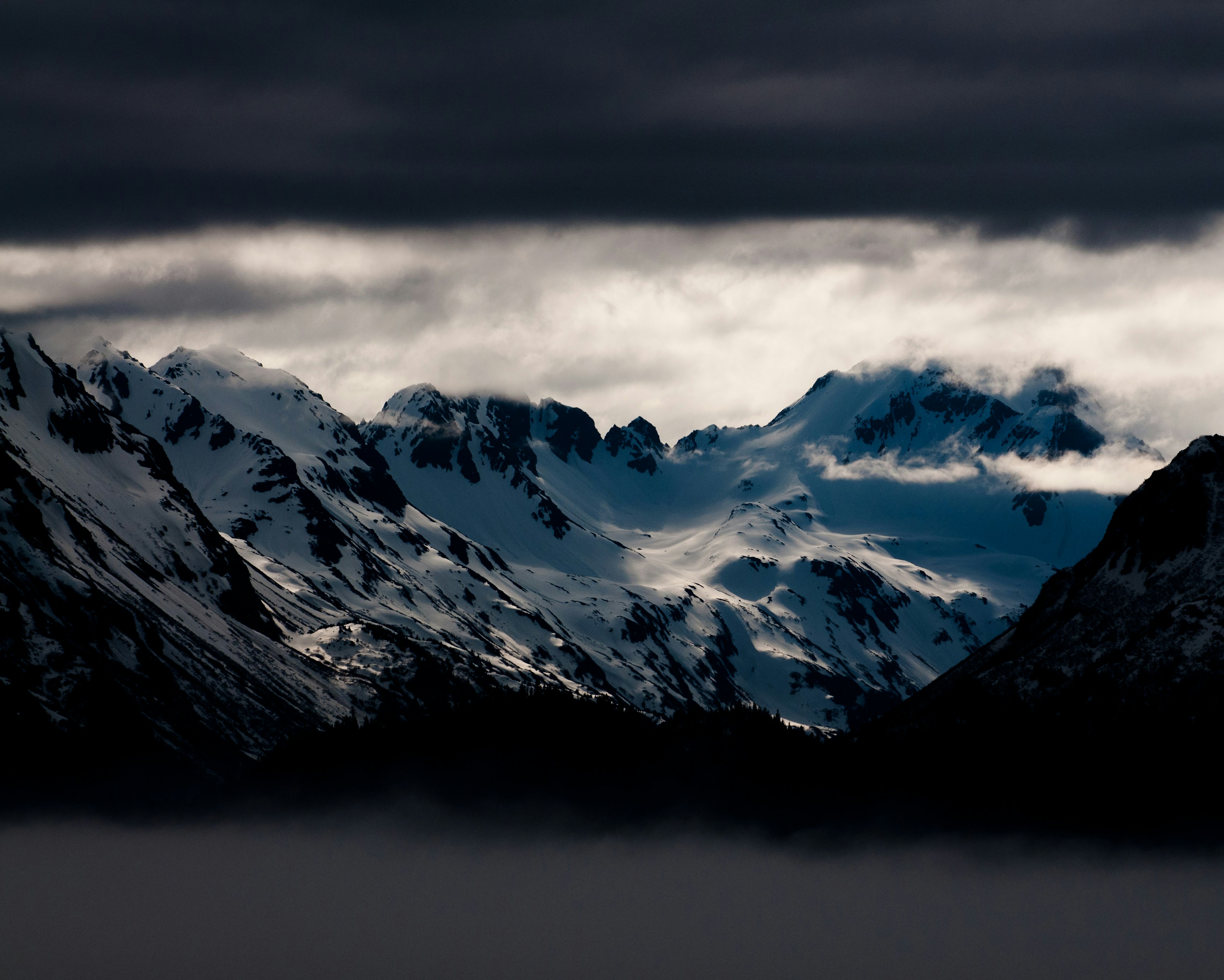 Snowy Mountain Range Under Overcast Sky