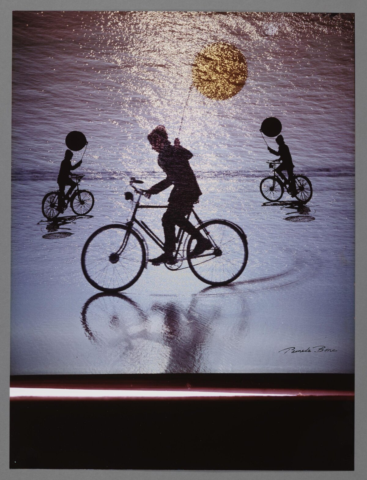 Silhouetted Cyclists on Beach at Sunset