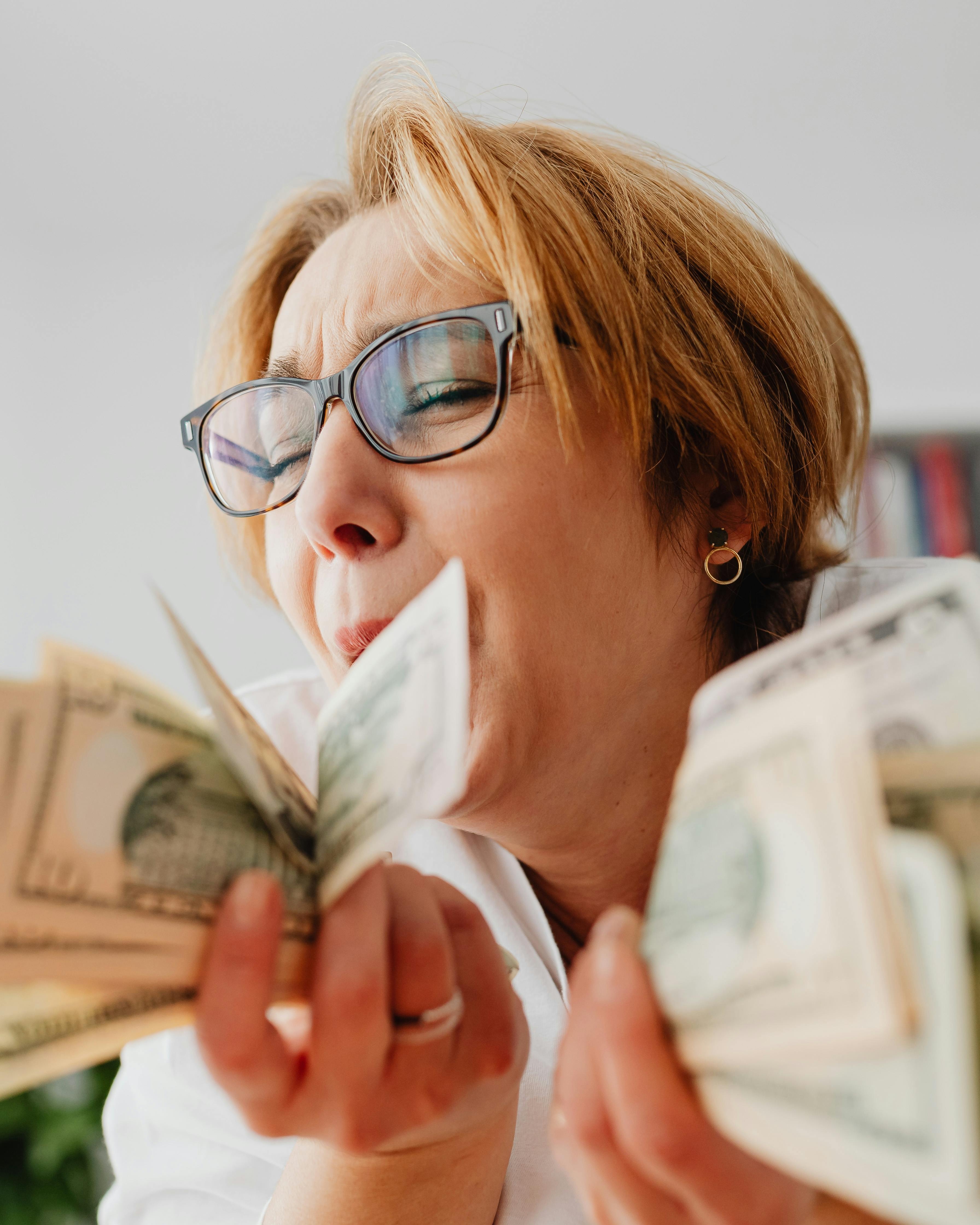 Happy Woman Counting Dollar Bills
