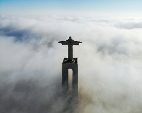 Christ Statue Above Sea of Clouds