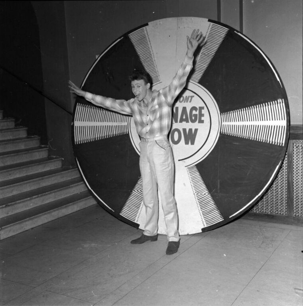 Man Posing In Front Of Giant Record Prop