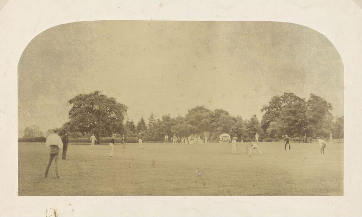 Vintage Cricket Match on Open Field