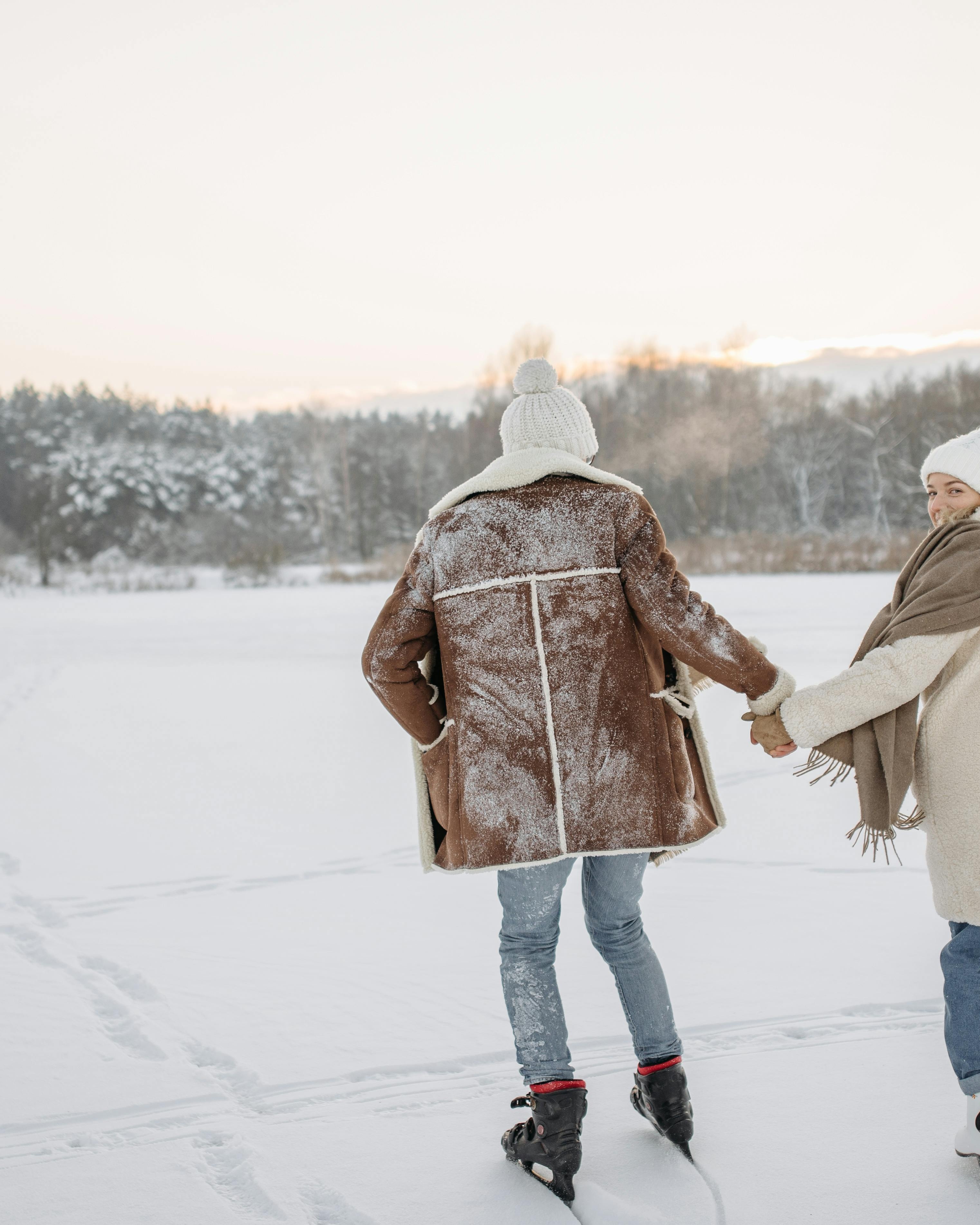 Couple Ice Skating on Frozen Winter Lake