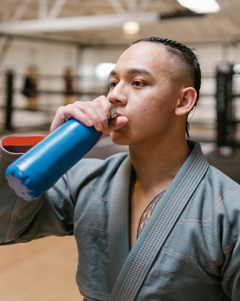 Martial Artist Drinking Water in Gym