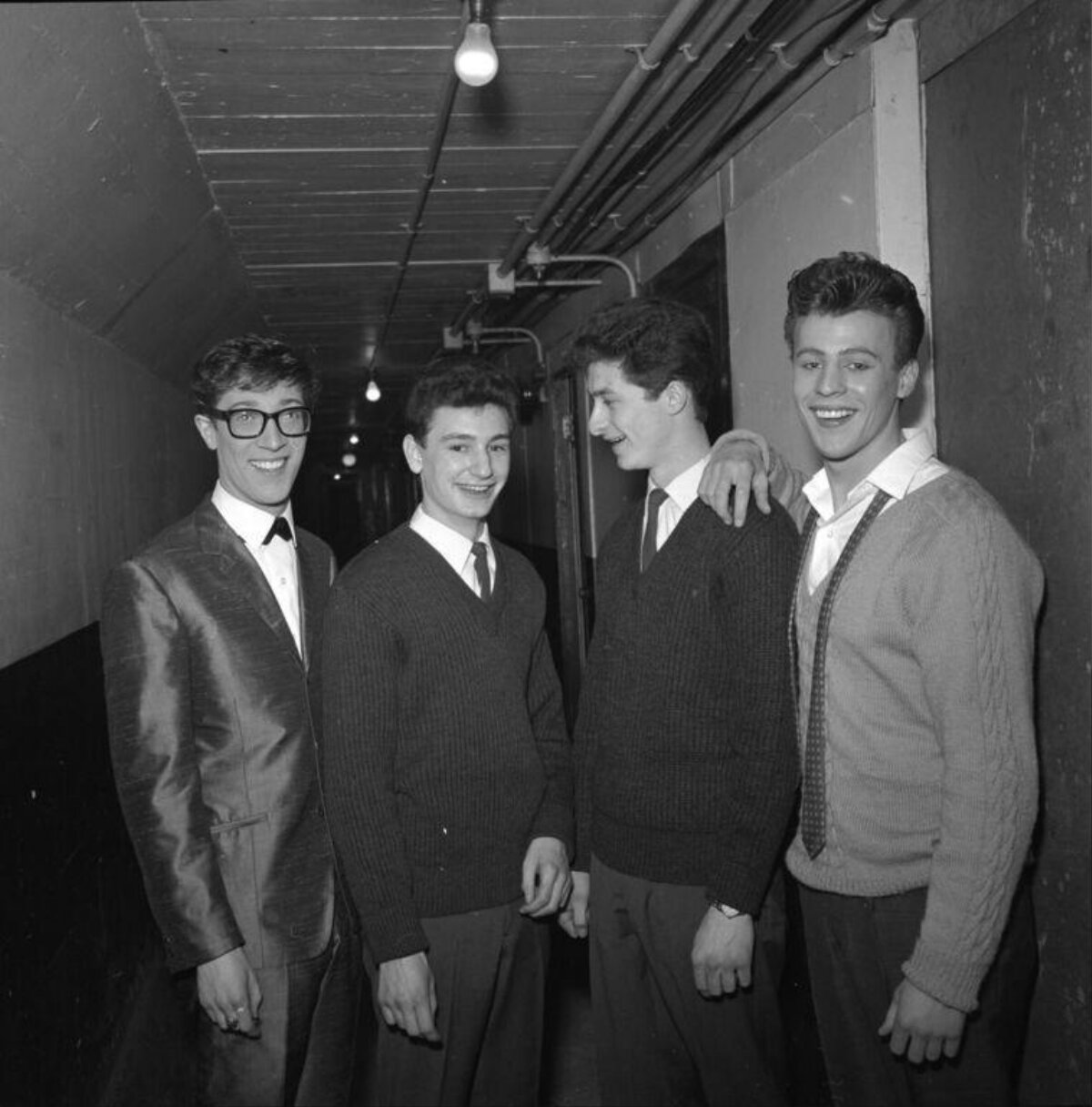 Four Young Men Posing in Corridor