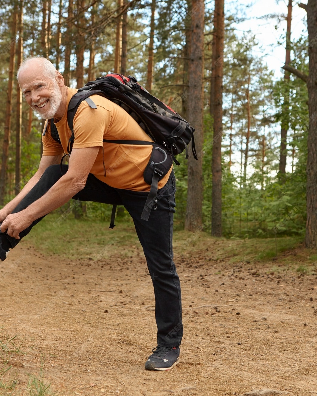 Senior Hiker Stretching in Forest