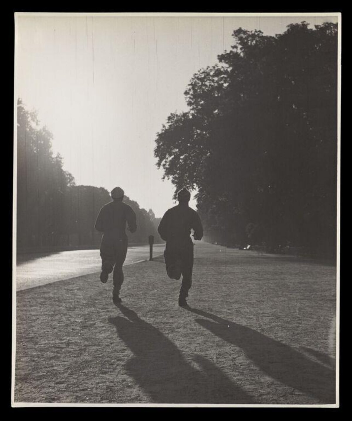 Two Runners Jogging on Park Path
