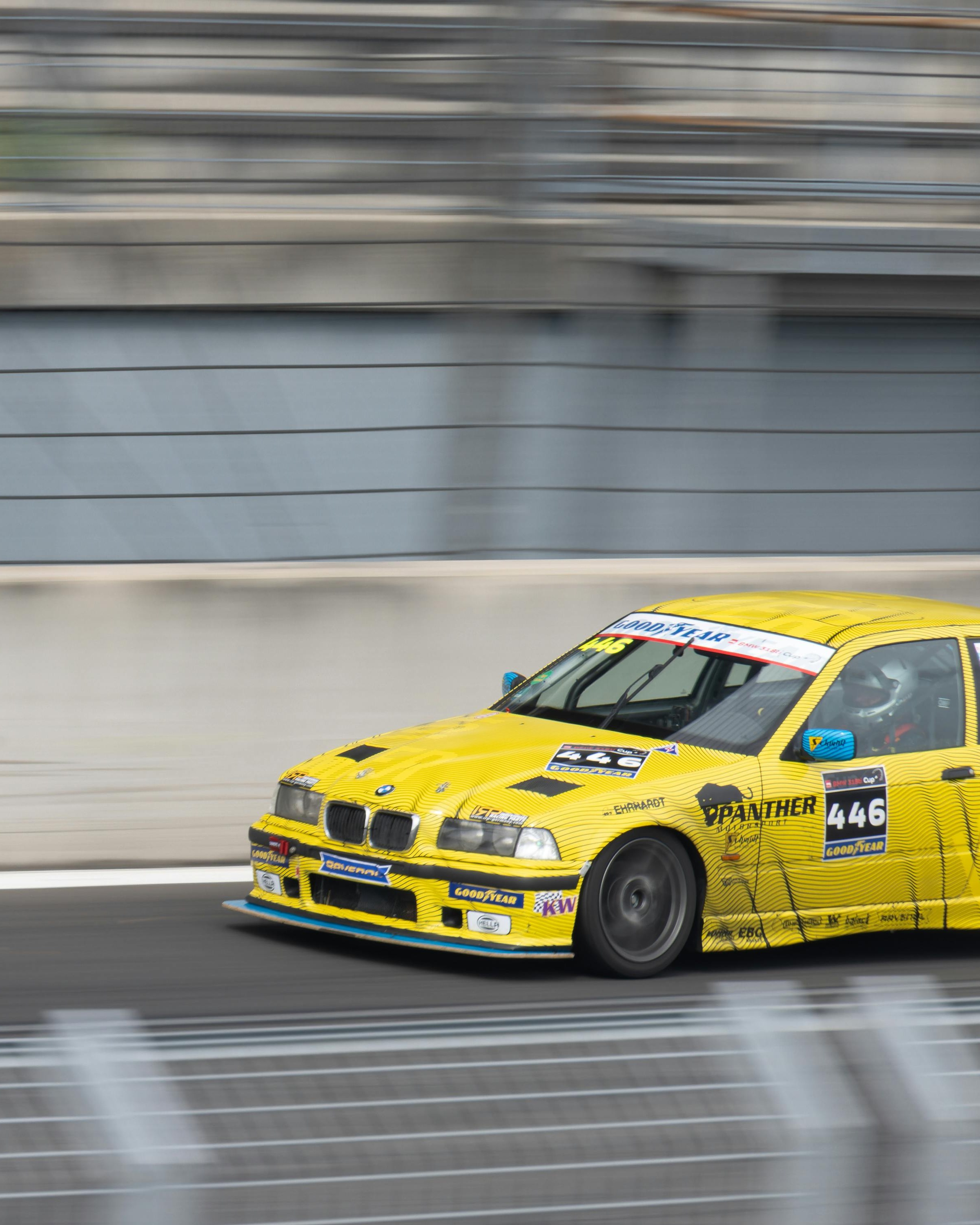 Yellow 446 Race Car Speeding on Track