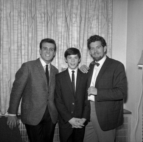Three Men In Suits Posing Together