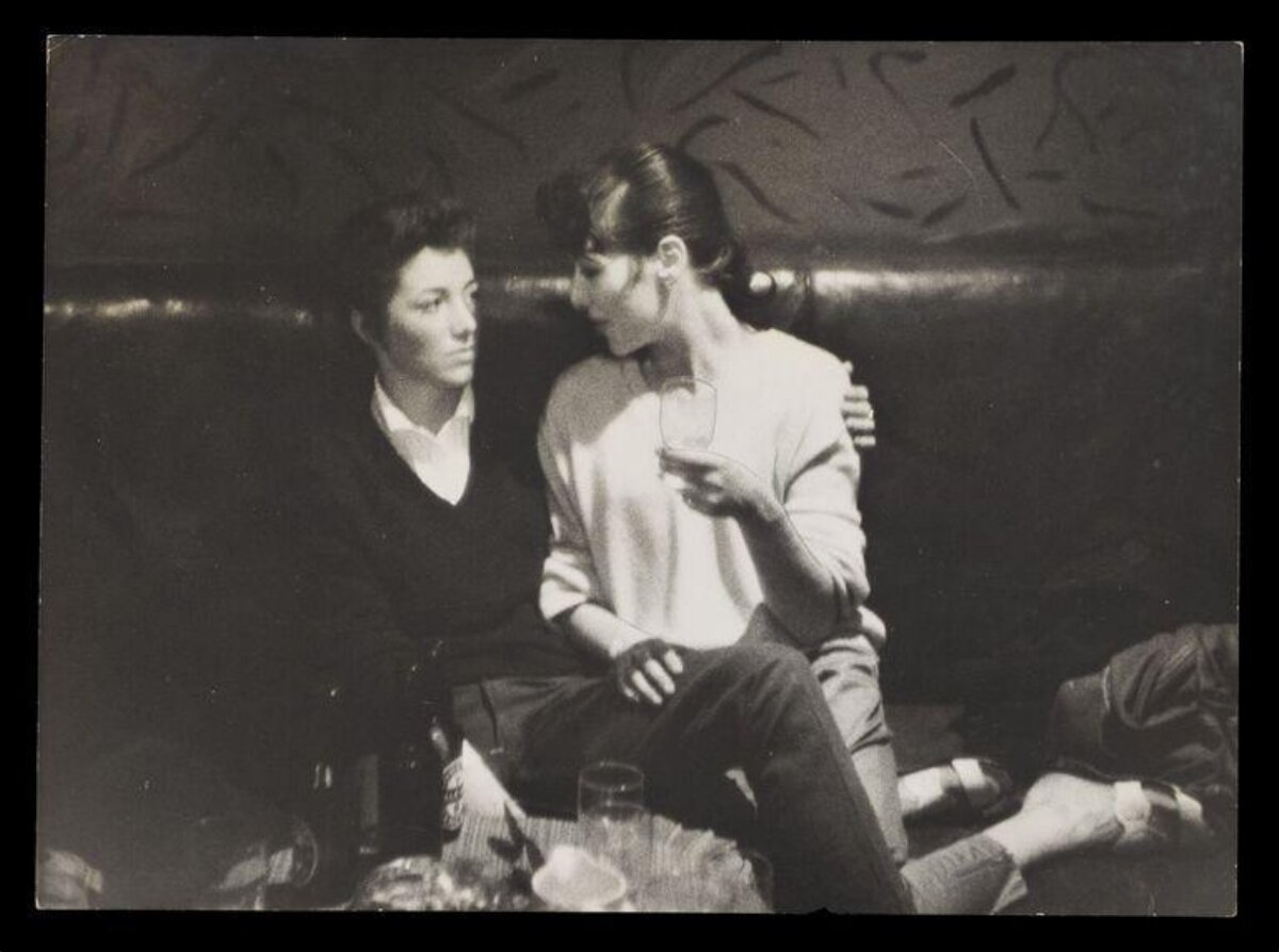 Two Women Chatting on Leather Sofa