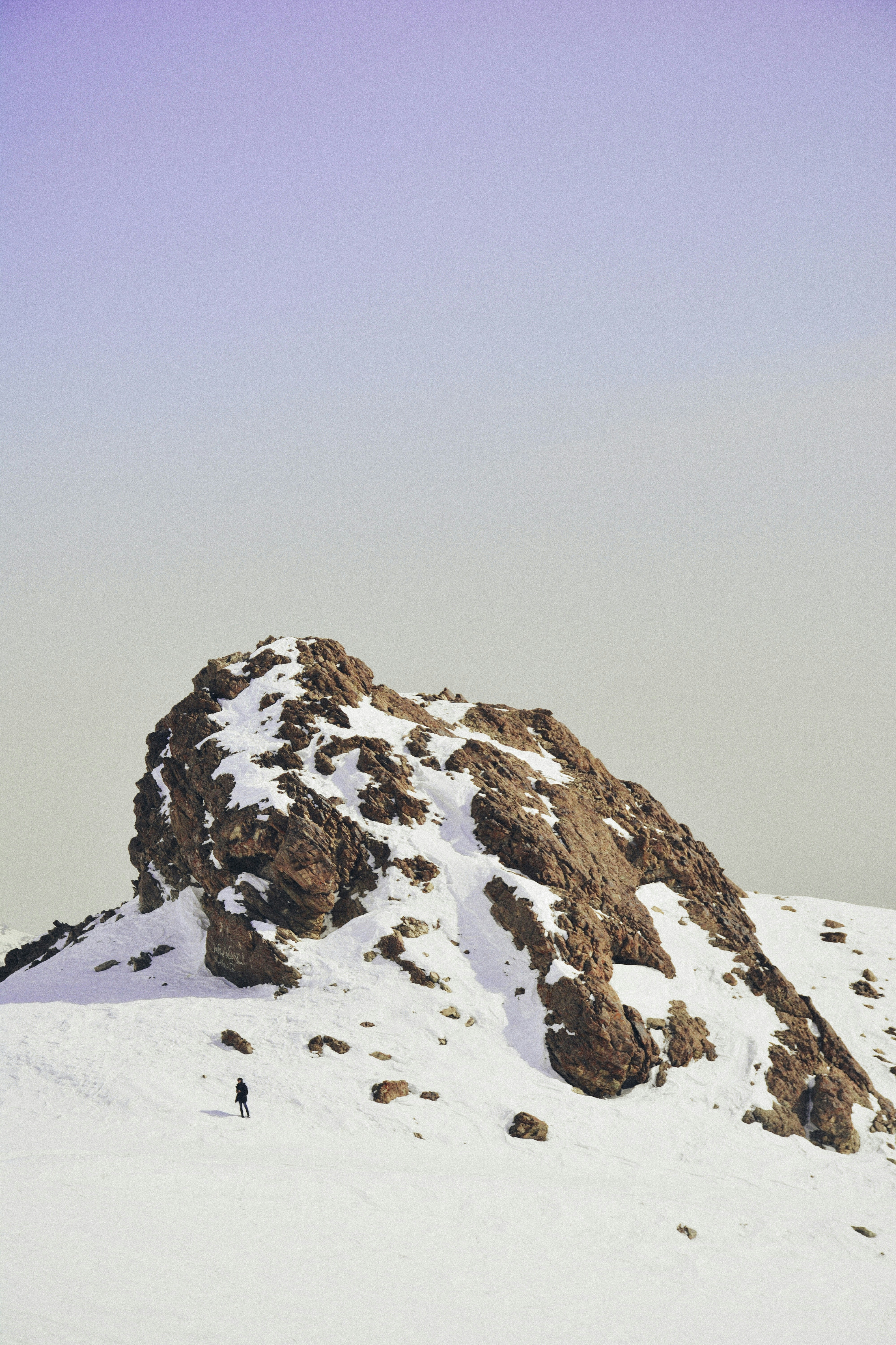 Lone Hiker on Snowy Mountain Slope