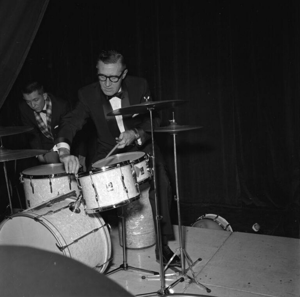 Two Drummers Performing On Stage