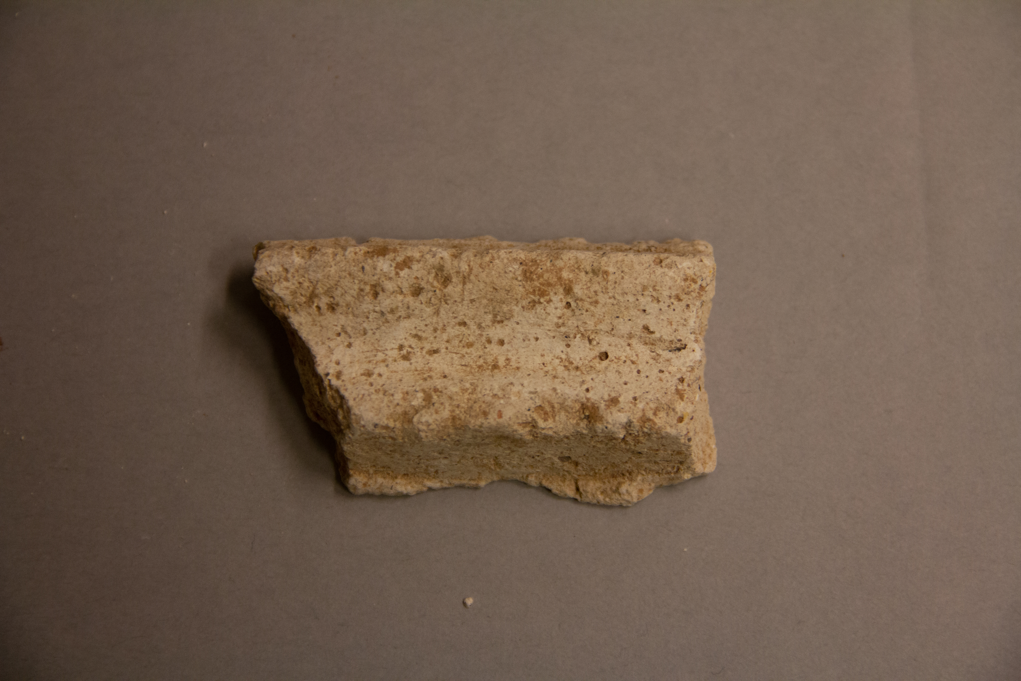Broken Stone Fragment on Gray Background