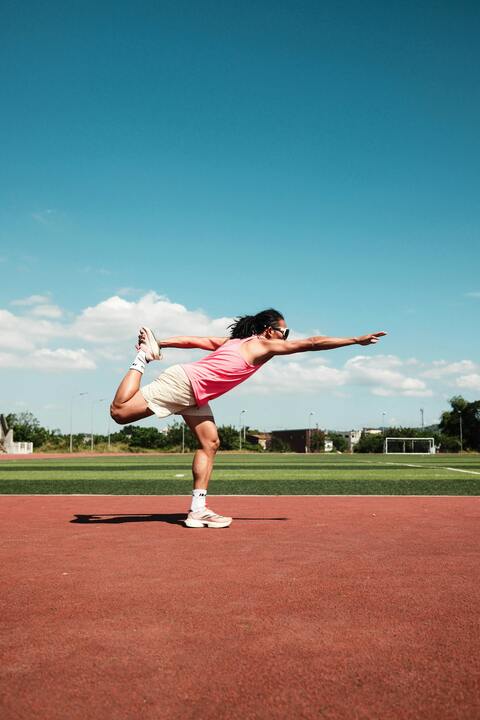 Athlete Stretching on Outdoor Running Track