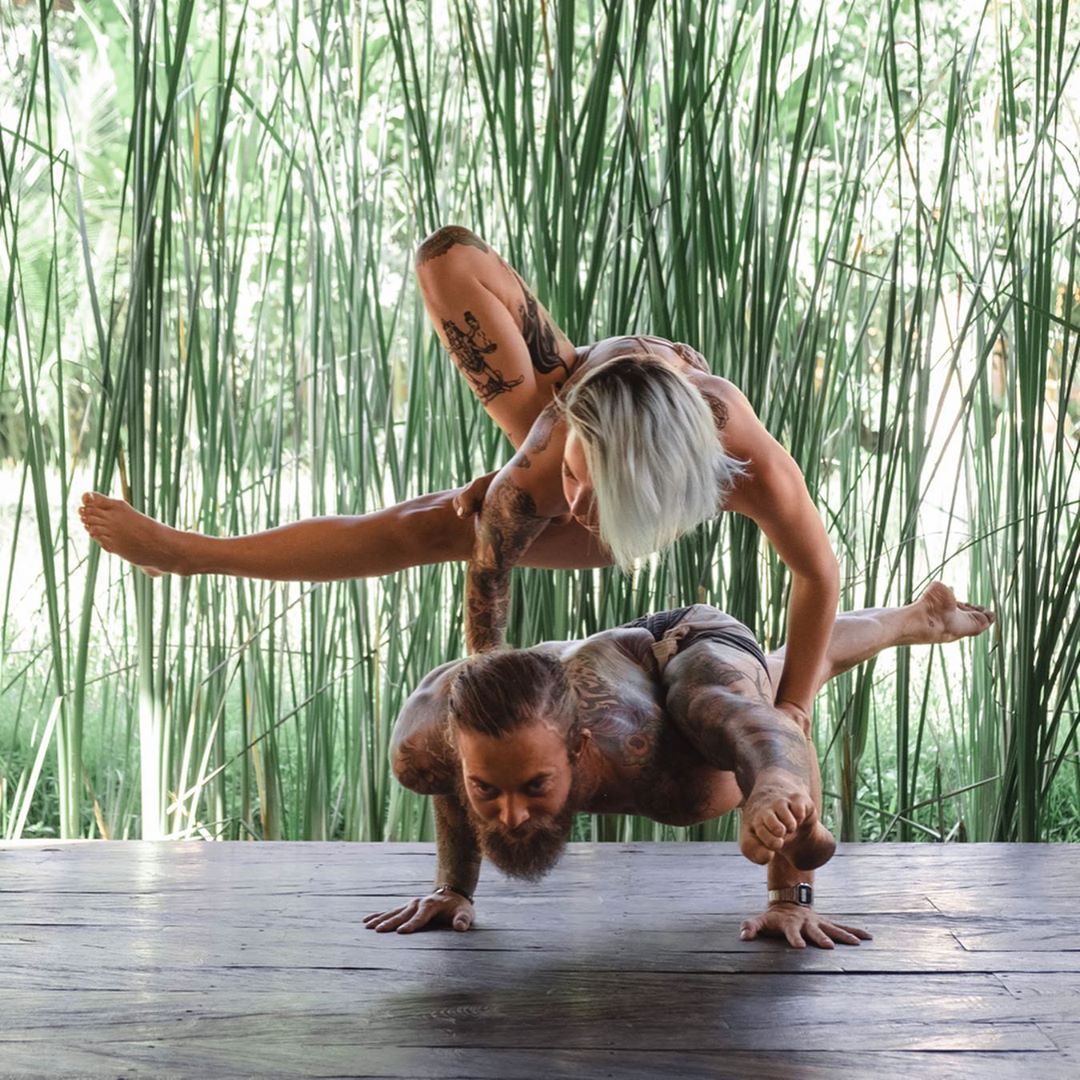 Two People Doing Acro Yoga Outdoors