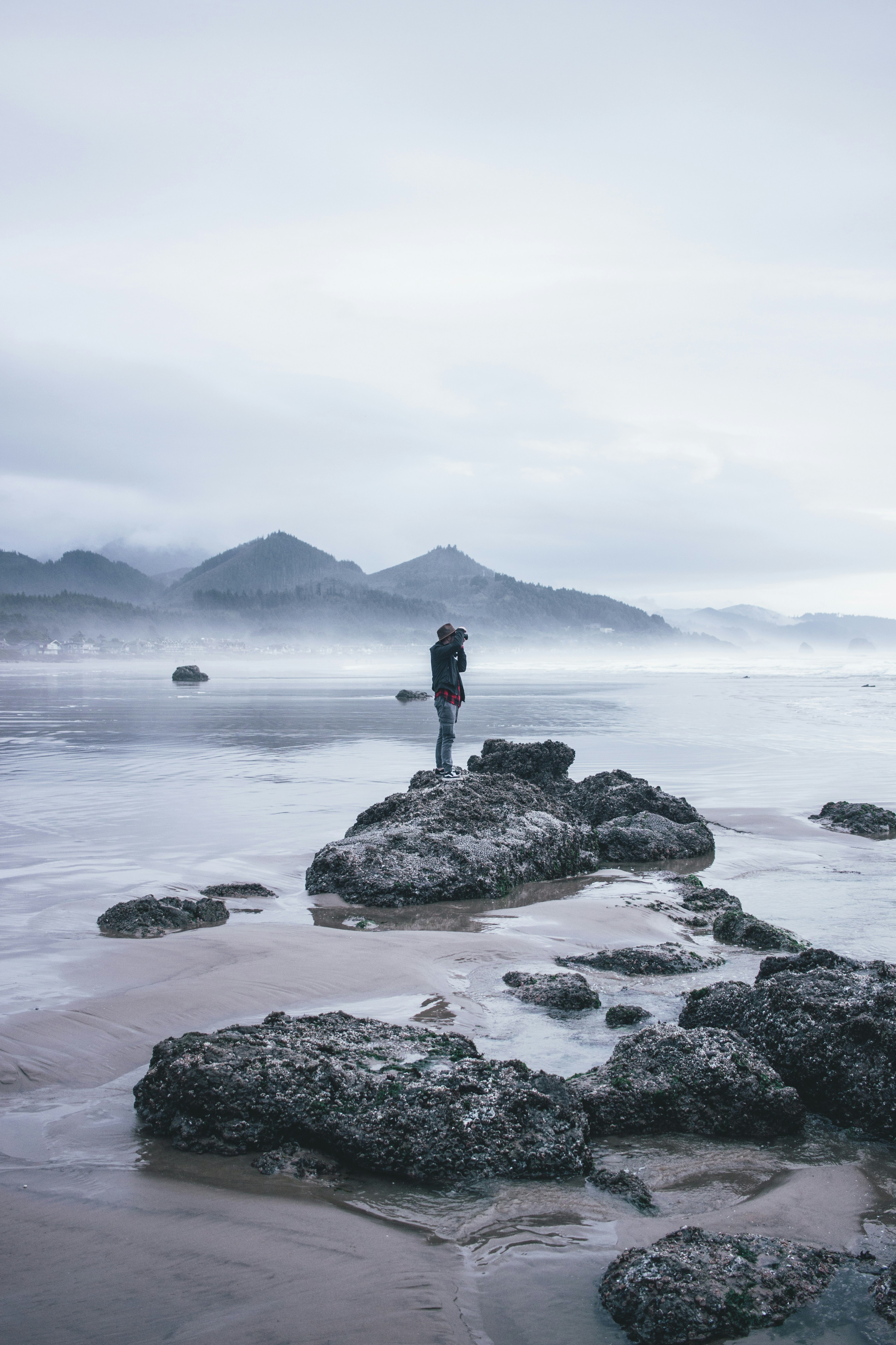 Photographer on Misty Coastal Beach