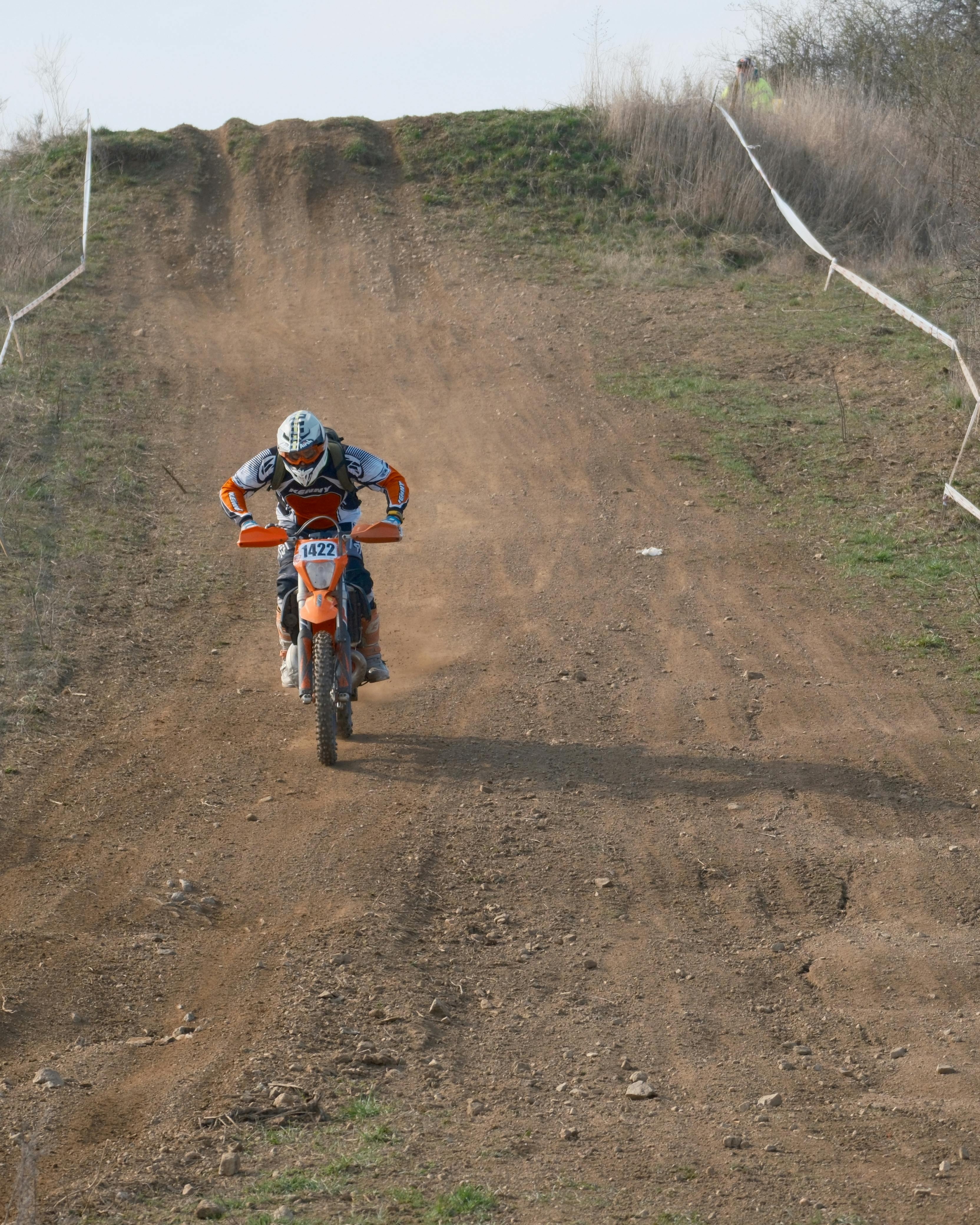 Motocross Rider Descending Dirt Trail