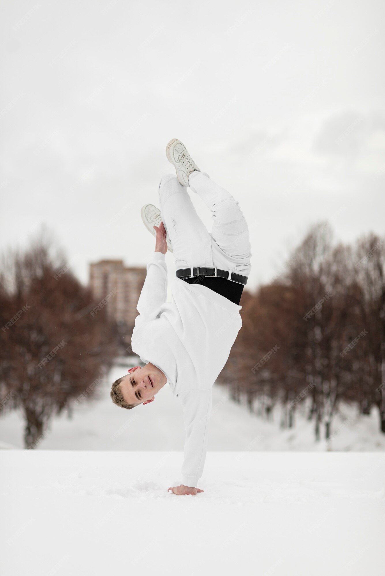 Breakdancer Balancing On One Hand In Snow