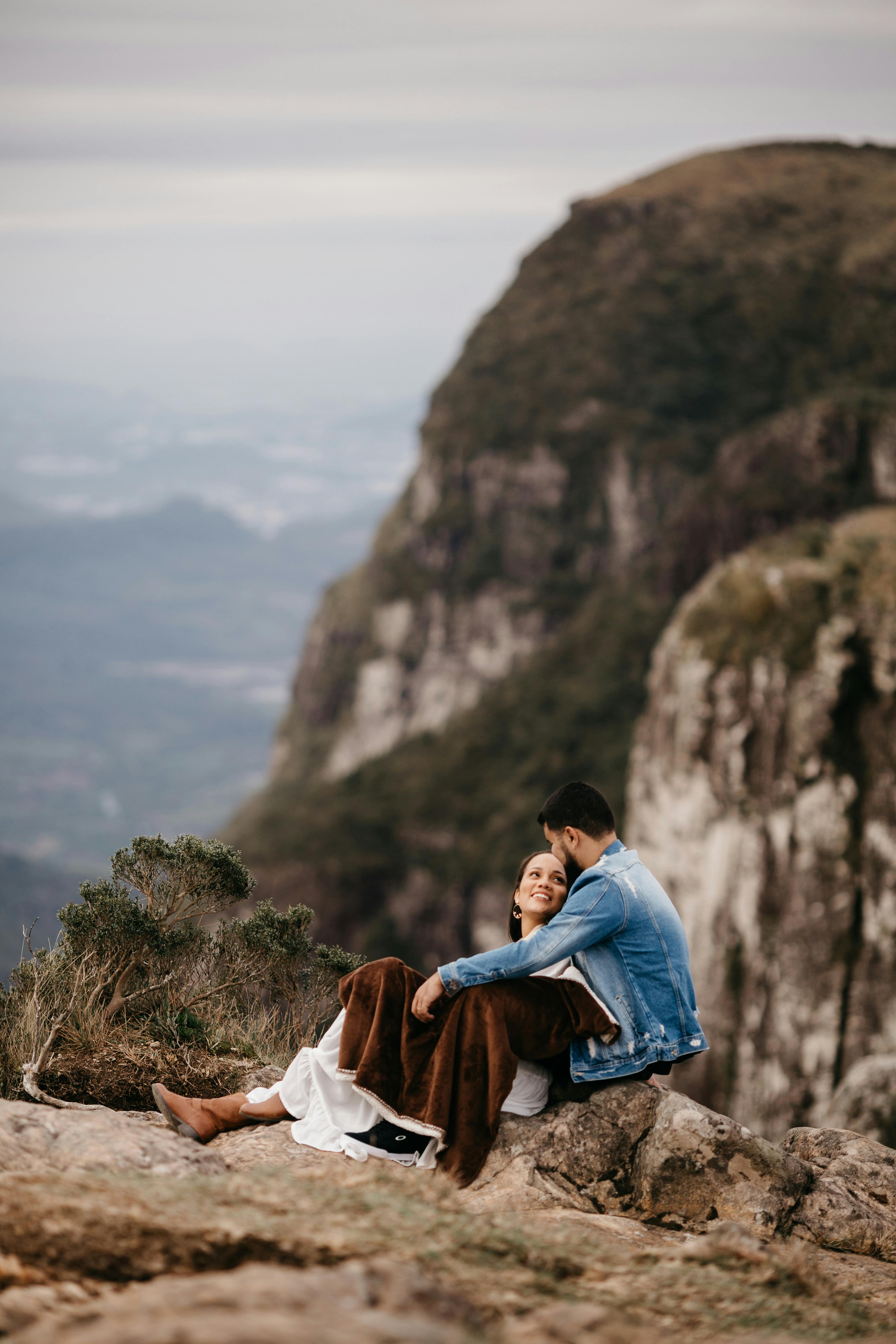 Couple Relaxing on Mountain Peak