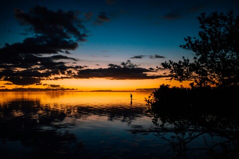 Fisherman Wading at Sunset