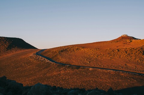 Winding Road on Arid Hills at Sunset
