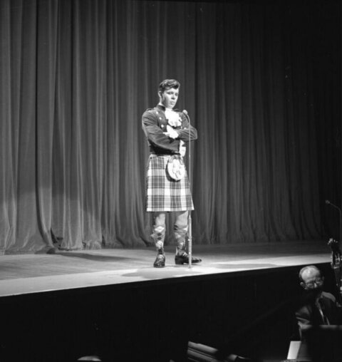 Performer in Kilt on Stage