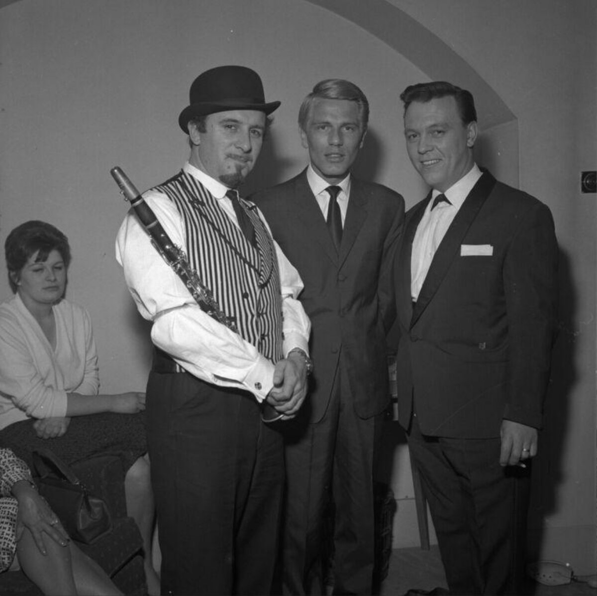 Three Men Posing With A Clarinet