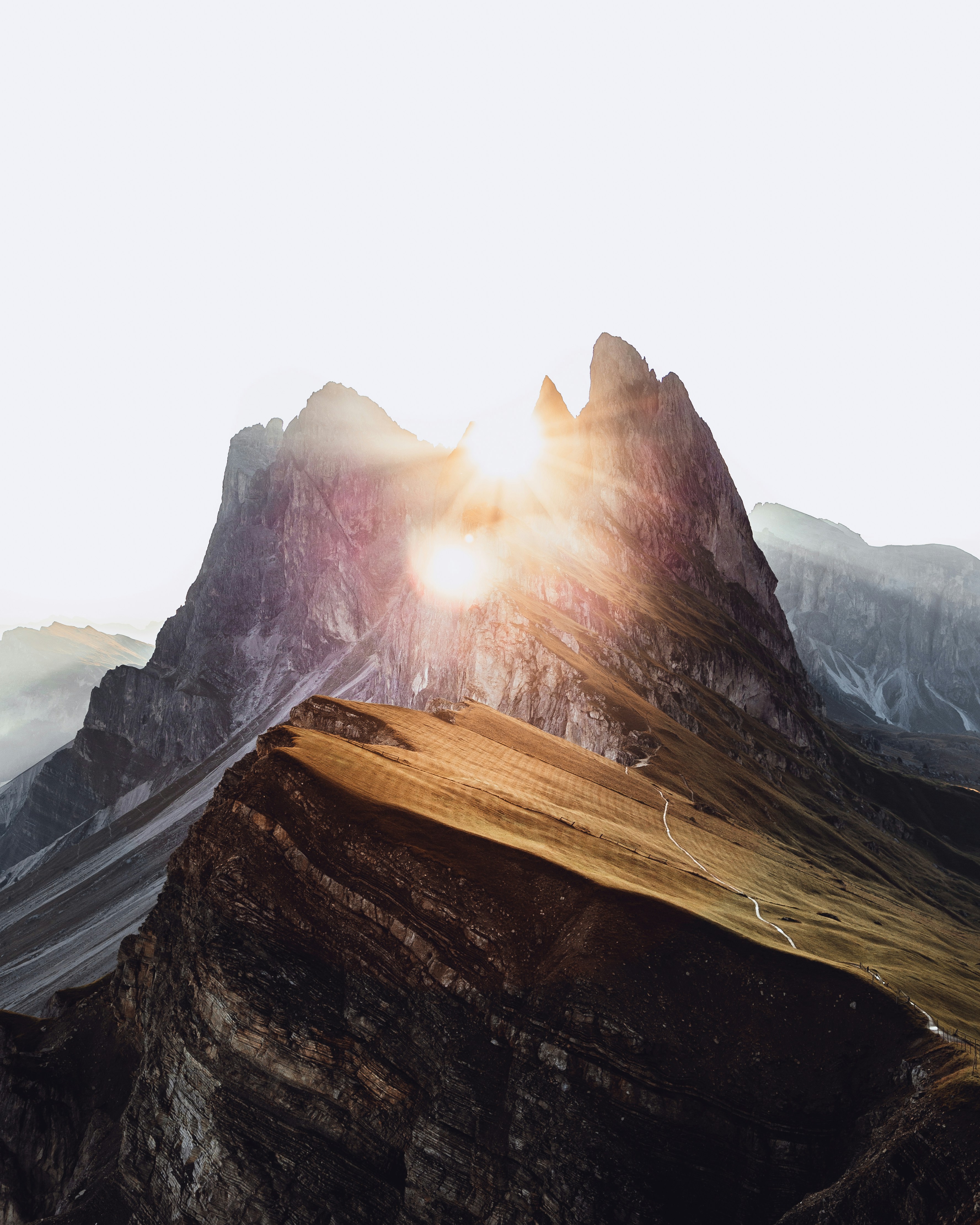 Sun Breaking Through Mountain Peaks