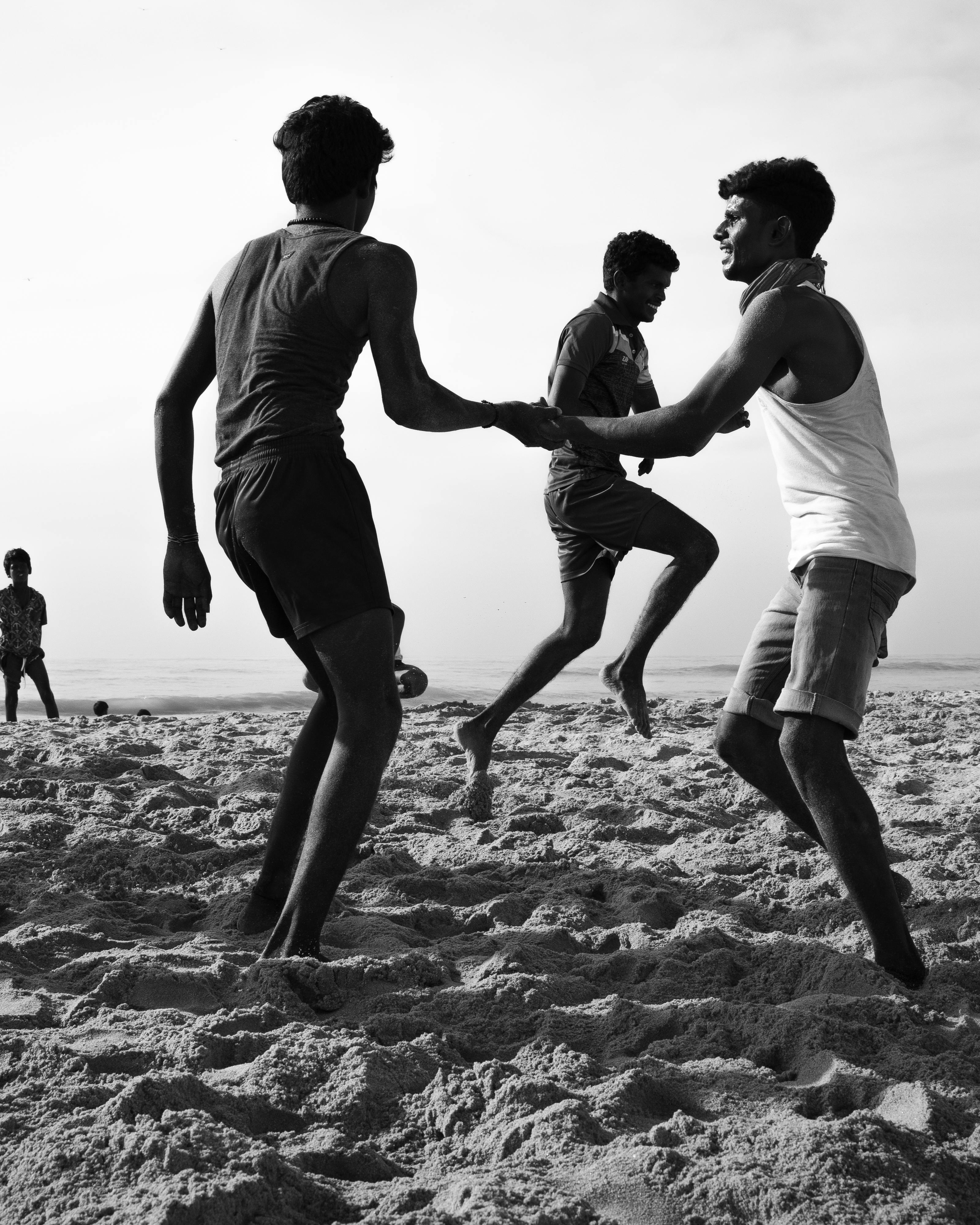 Young Men Playing Game on Beach