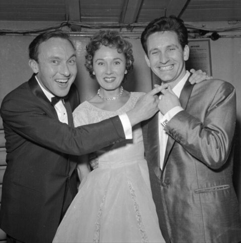 Three Smiling People in Formal Attire