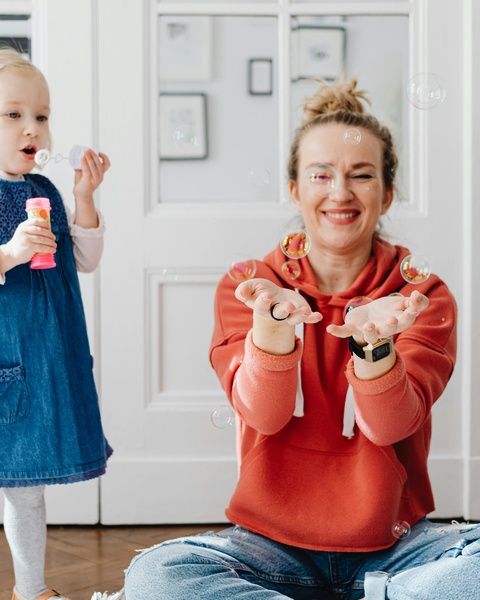 Mother and Daughter Playing with Bubbles