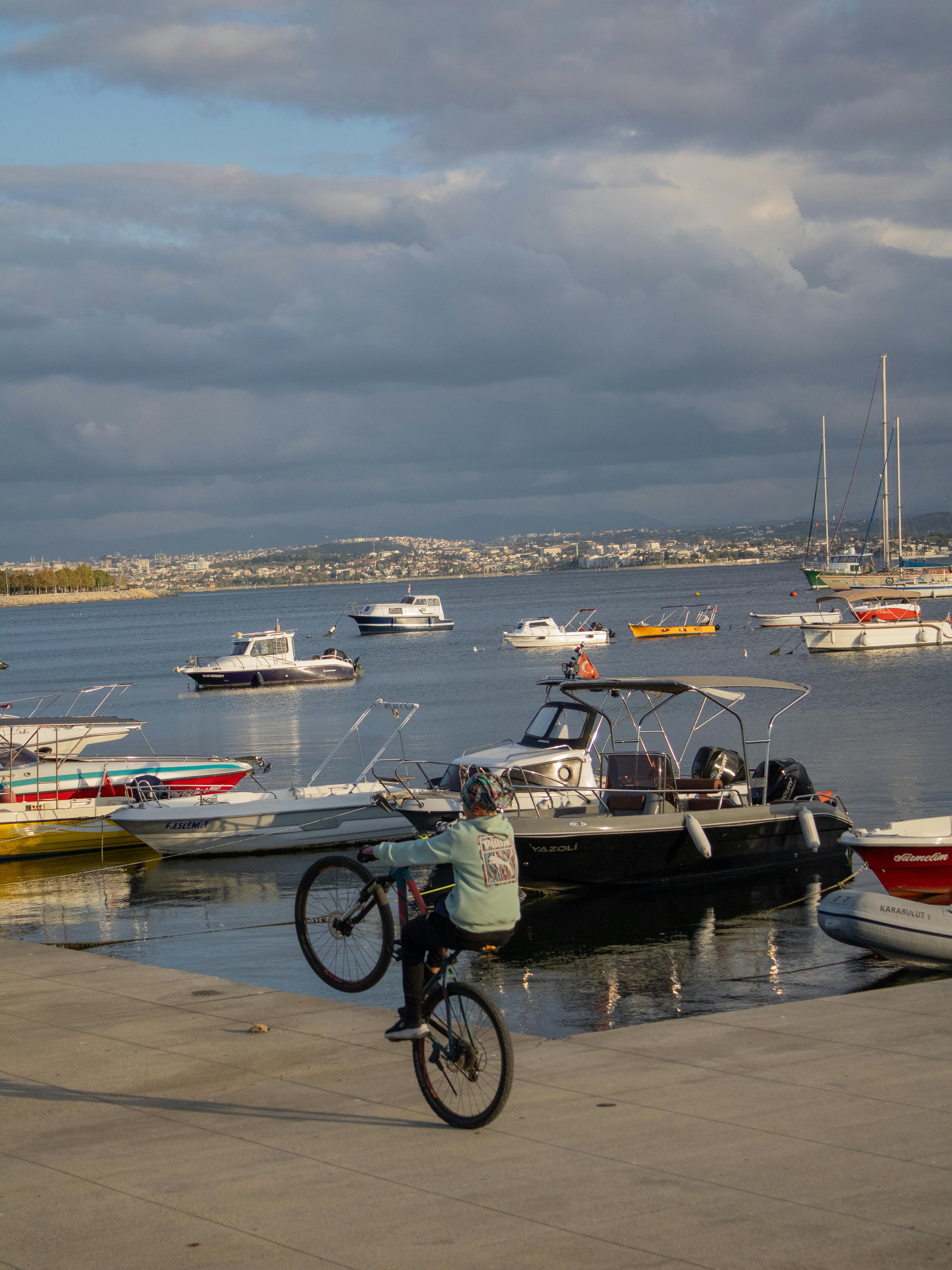 Cyclist Doing Wheelie at Coastal Marina