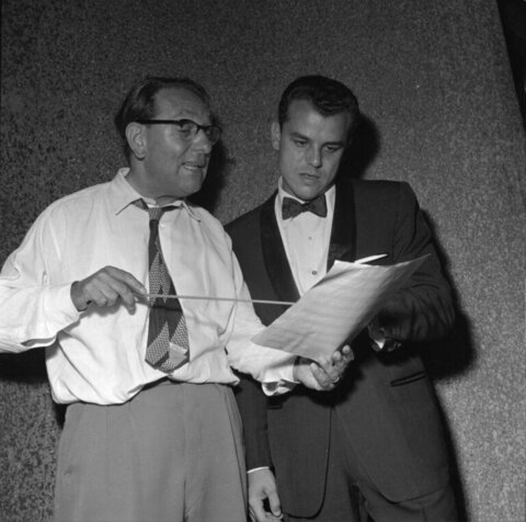 Two Musicians Discussing Sheet Music