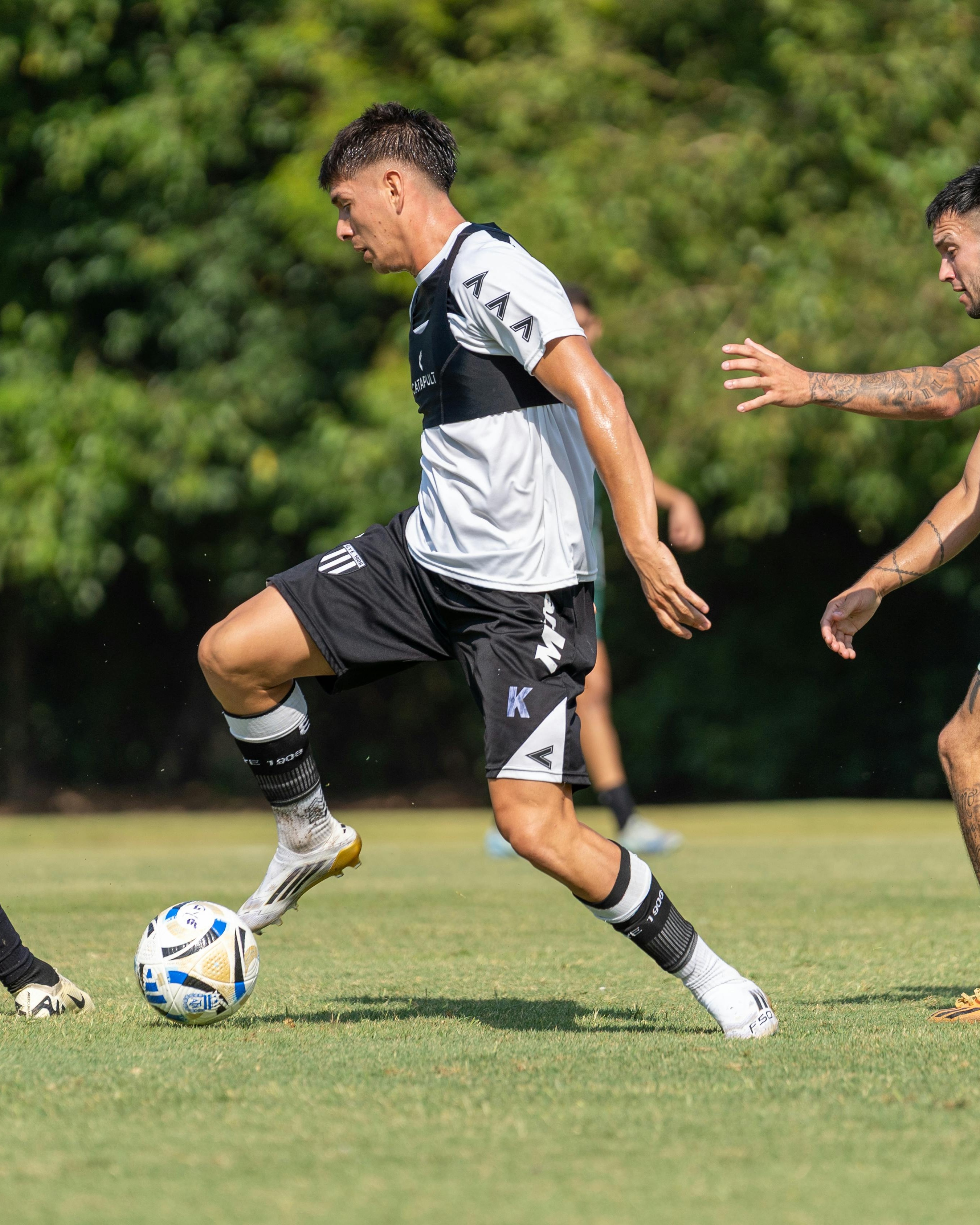 Soccer Player Training on Grass Field