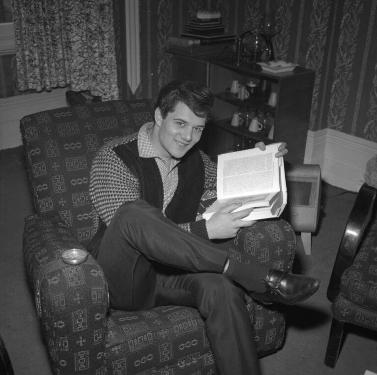 Young Man Reading a Book at Home