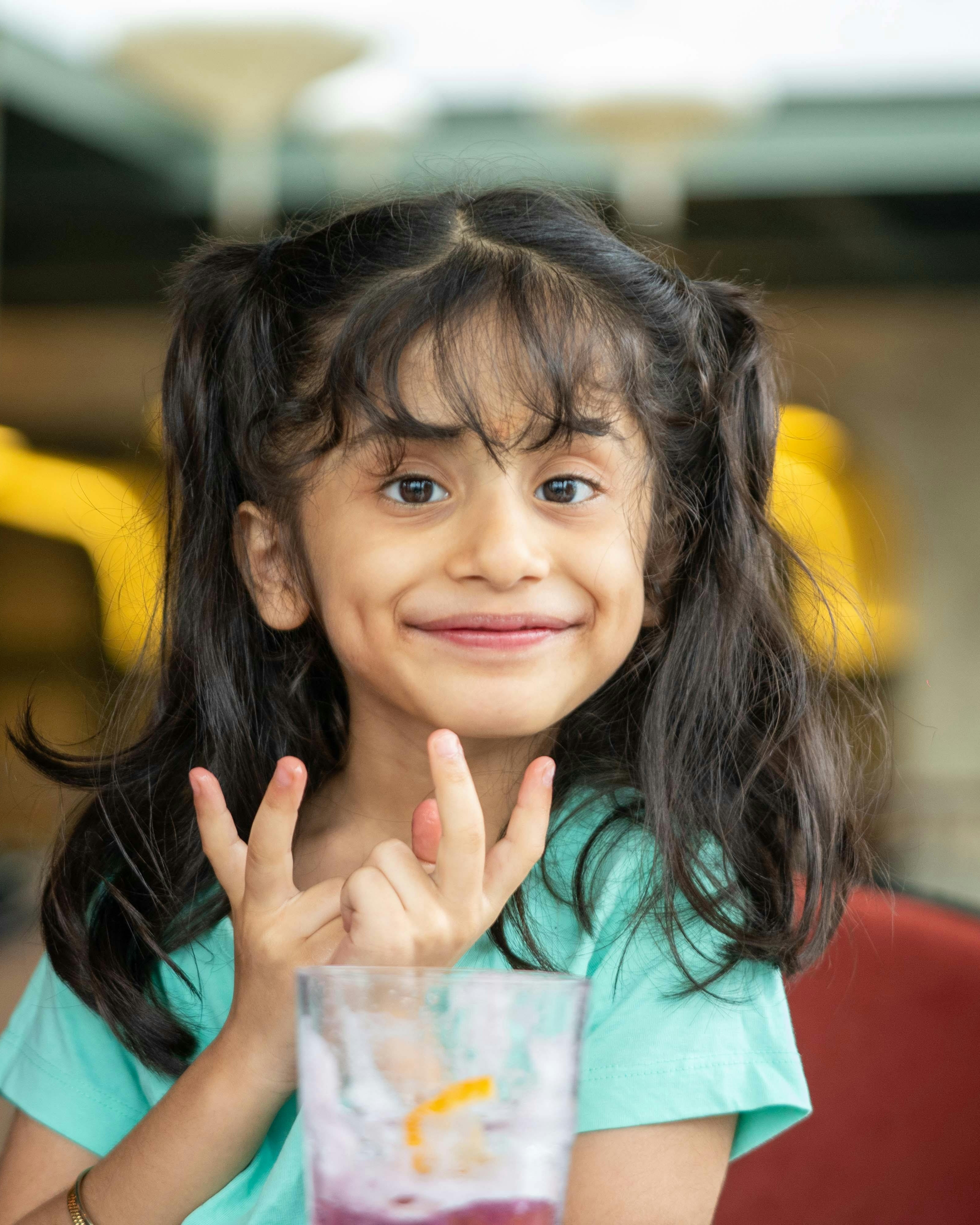 Smiling Little Girl With Hand Gestures
