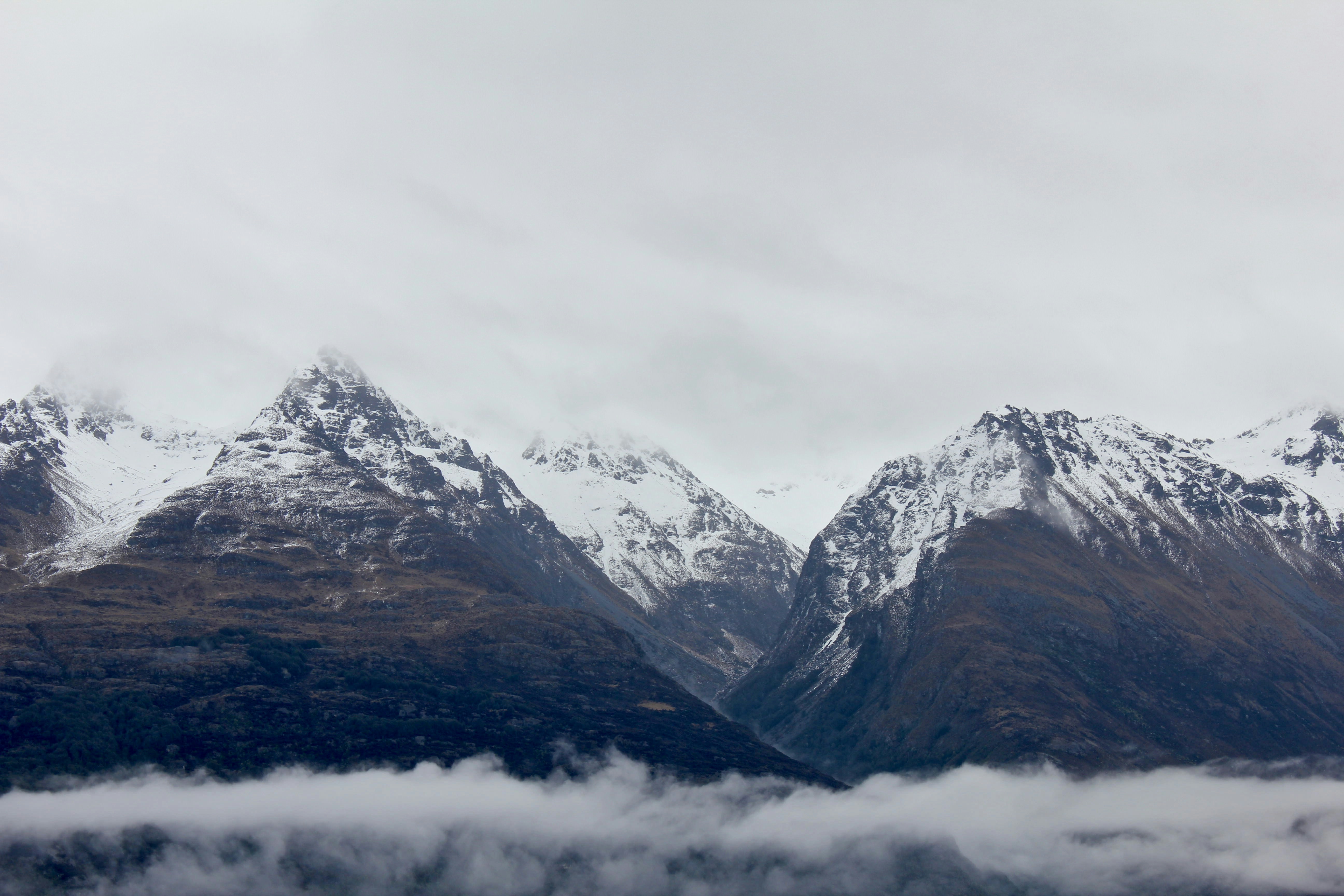 Snow-capped Mountains Under Cloudy Sky