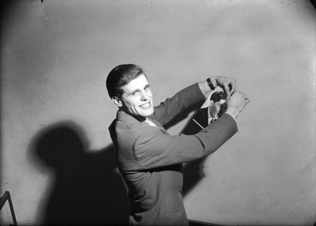 Man Tearing His Own Portrait Photo